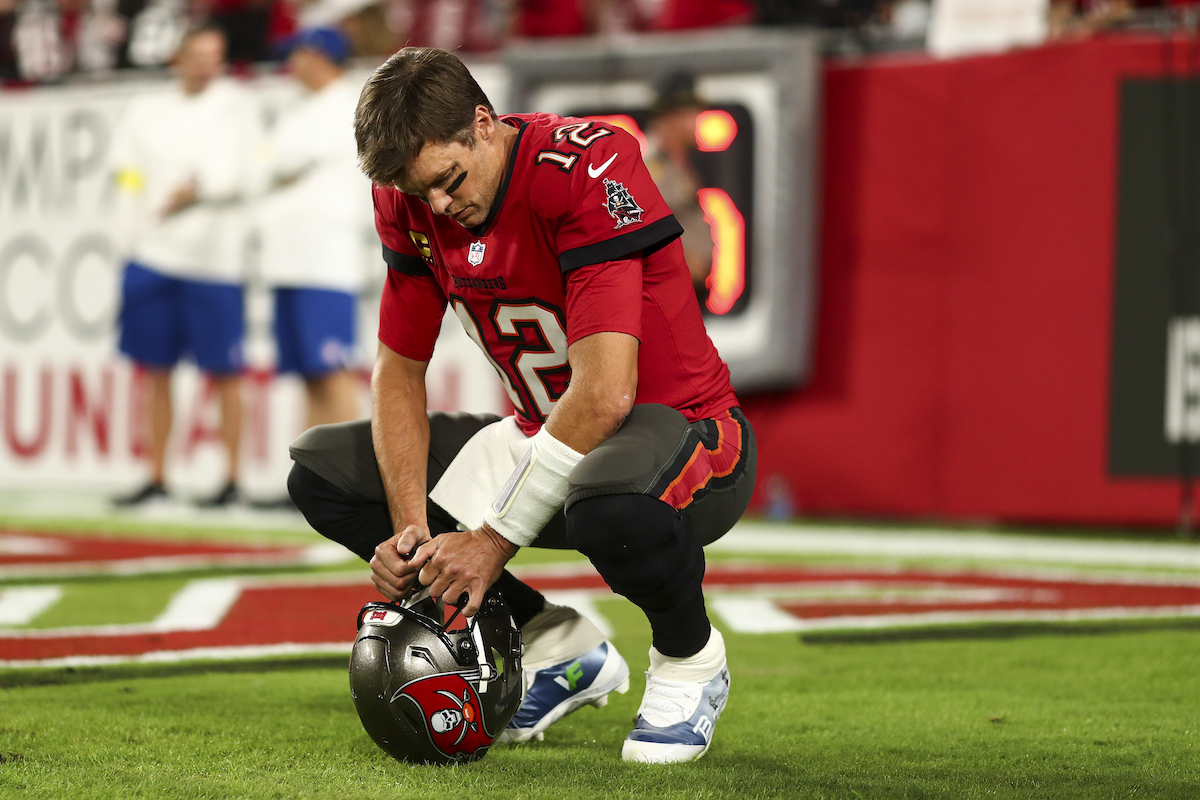 Tom Brady of the Tampa Bay Buccaneers kneels in the end zone prior to an NFL game