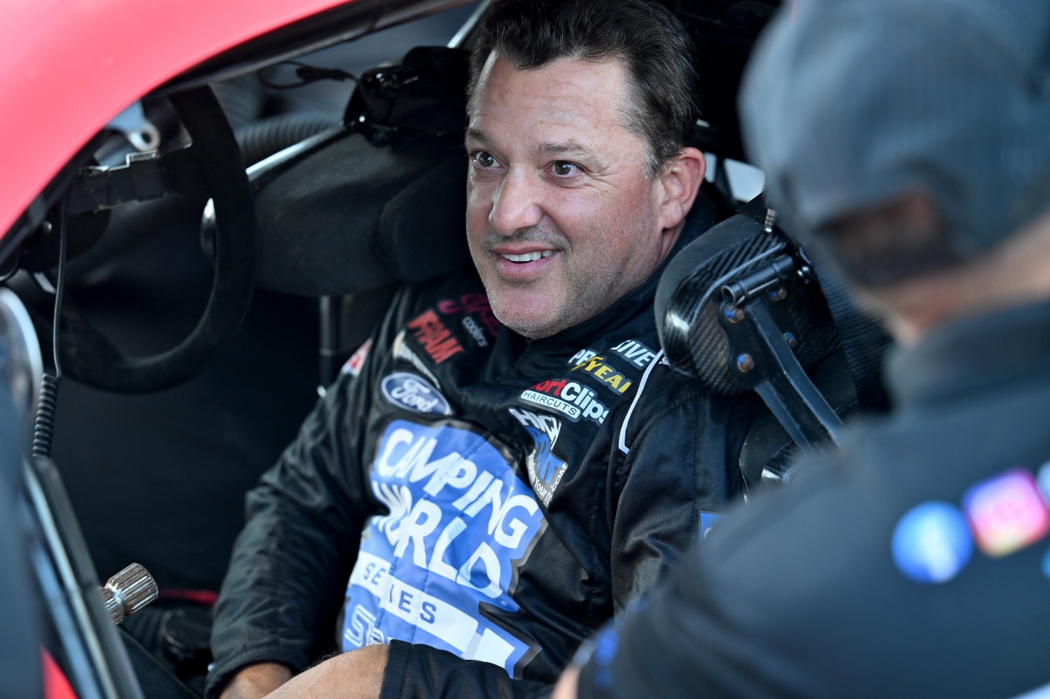 Tony Stewart talks with his crew prior to the start of the SRX qualifying race at Sharon Speedway on July 23, 2022.