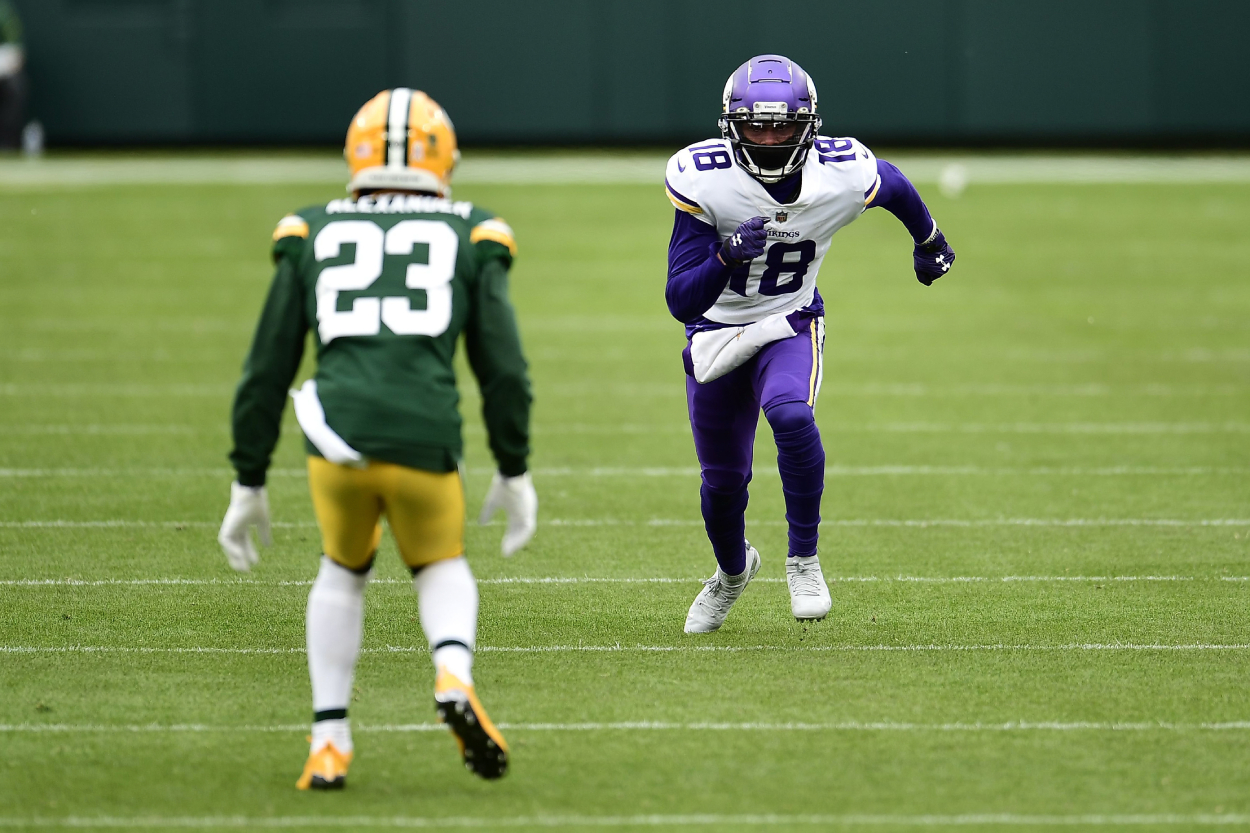 Justin Jefferson #18 of the Minnesota Vikings works against Jaire Alexander #23 of the Green Bay Packers.