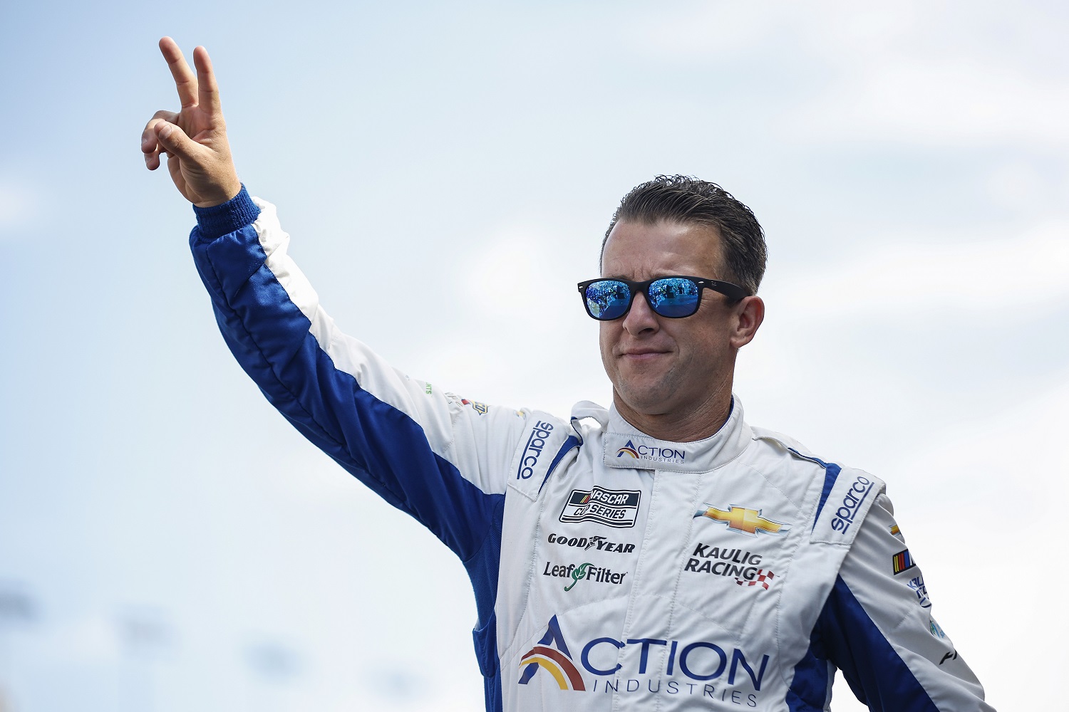 AJ Allmendinger waves to fans as he walks onstage during driver intros for the NASCAR Cup Series South Point 400 at Las Vegas Motor Speedway on Oct. 16, 2022.