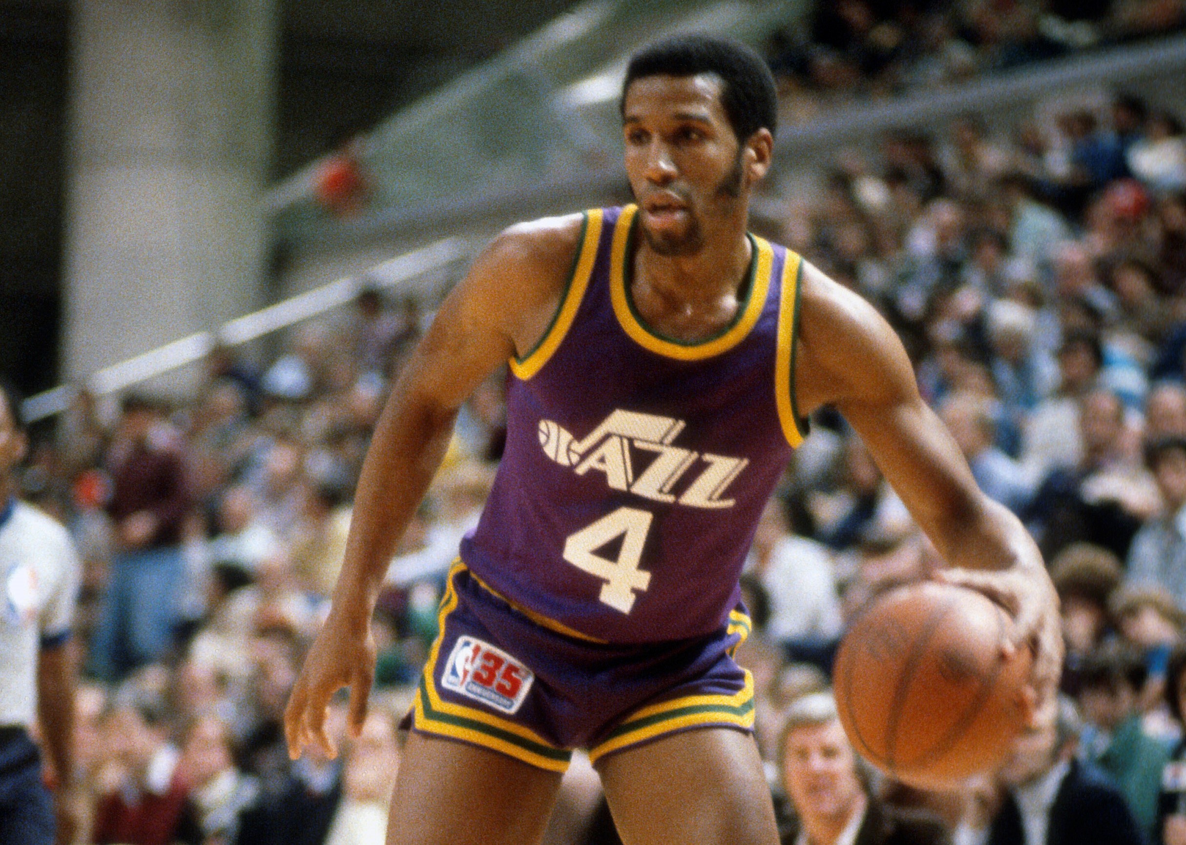 Adrian Dantley of the Utah Jazz dribbles the ball against the New Jersey Nets.
