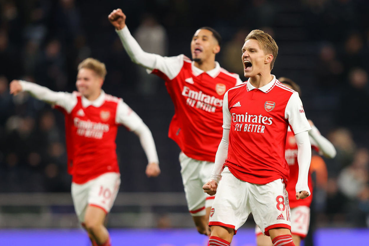 Arsenal captain Martin Odegaard (R) celebrates a North London Derby win with his teammates.
