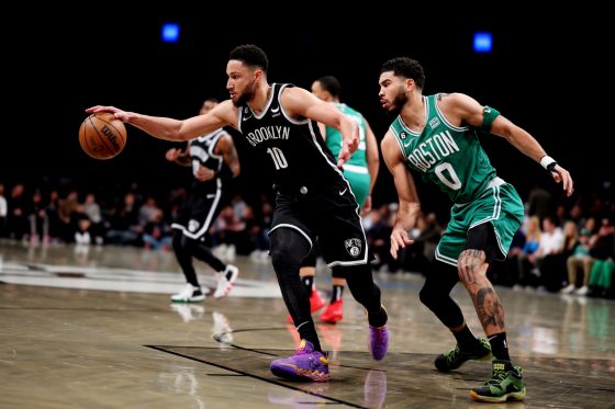 Ben Simmons of the Brooklyn Nets and Jayson Tatum of the Boston Celtics battle for the ball.