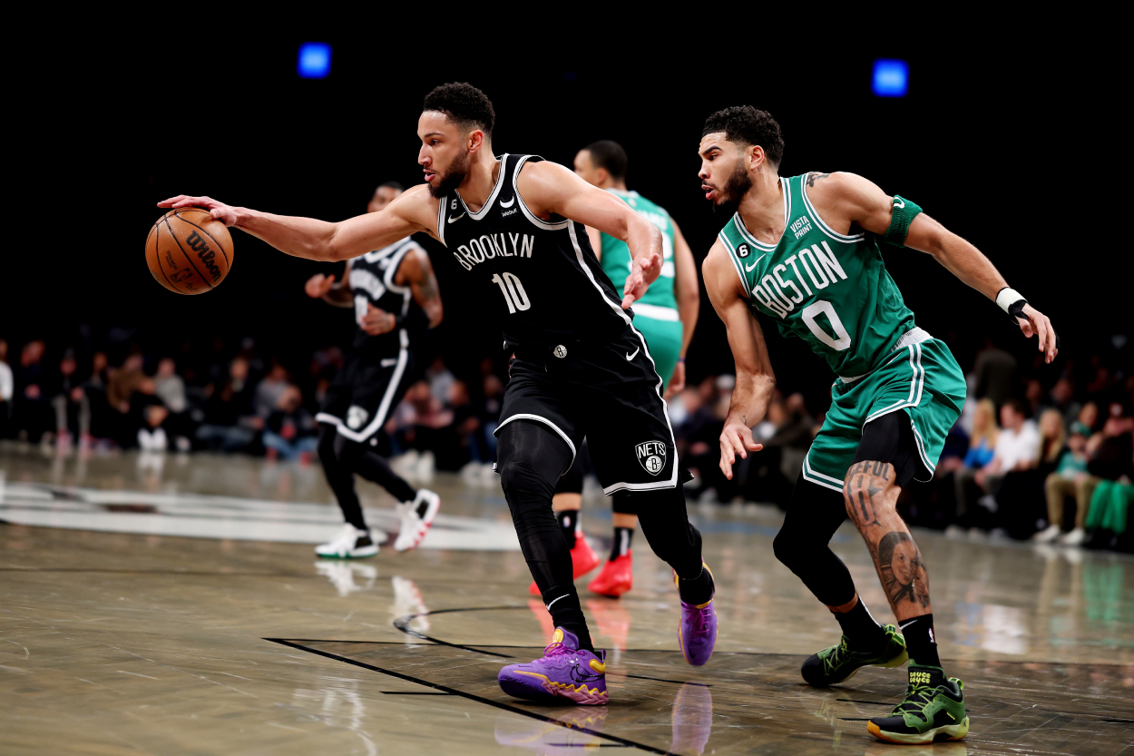 Ben Simmons of the Brooklyn Nets and Jayson Tatum of the Boston Celtics battle for the ball.
