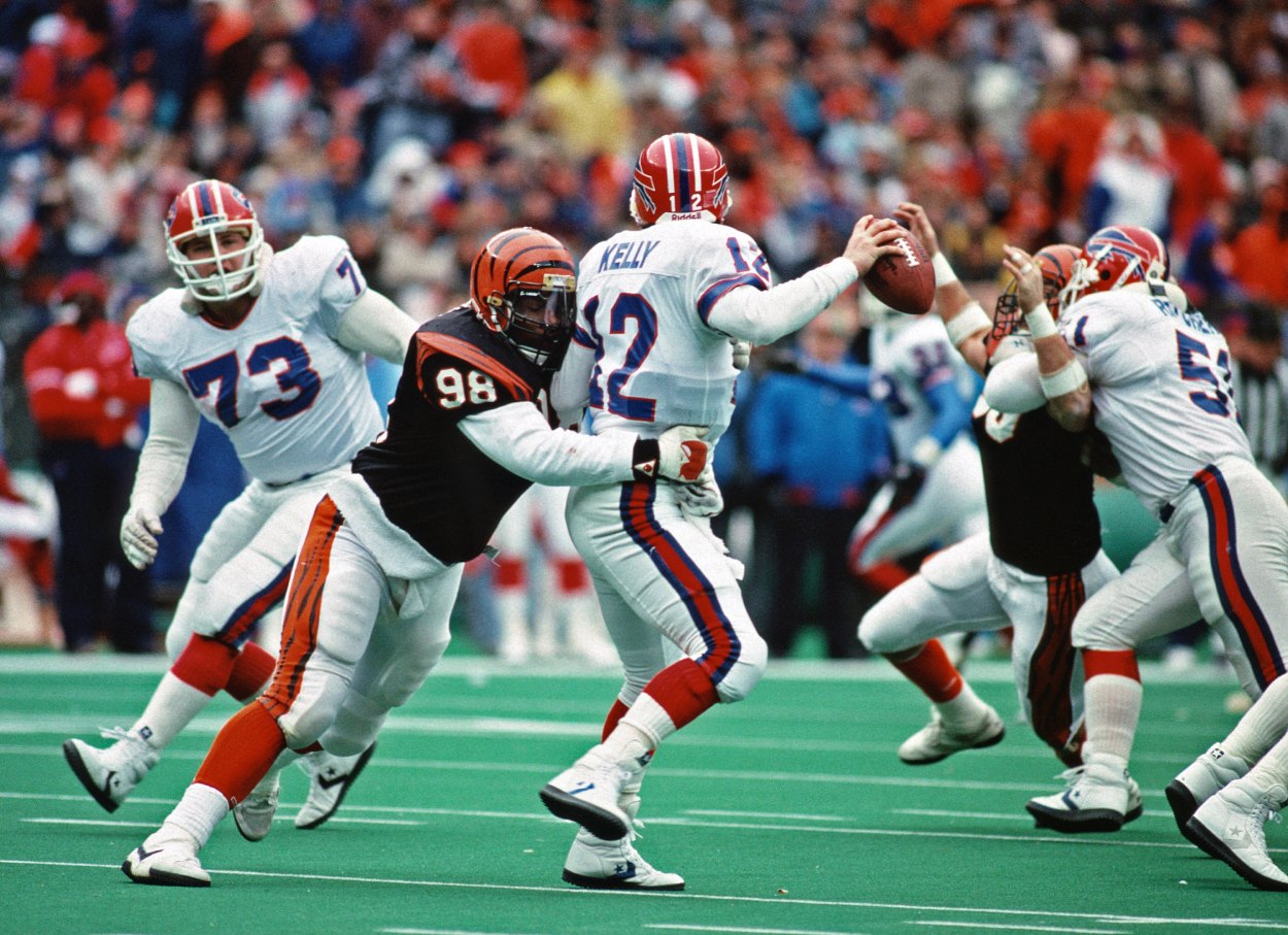 Defensive lineman David Grant of the Cincinnati Bengals sacks quarterback Jim Kelly of the Buffalo Bills.