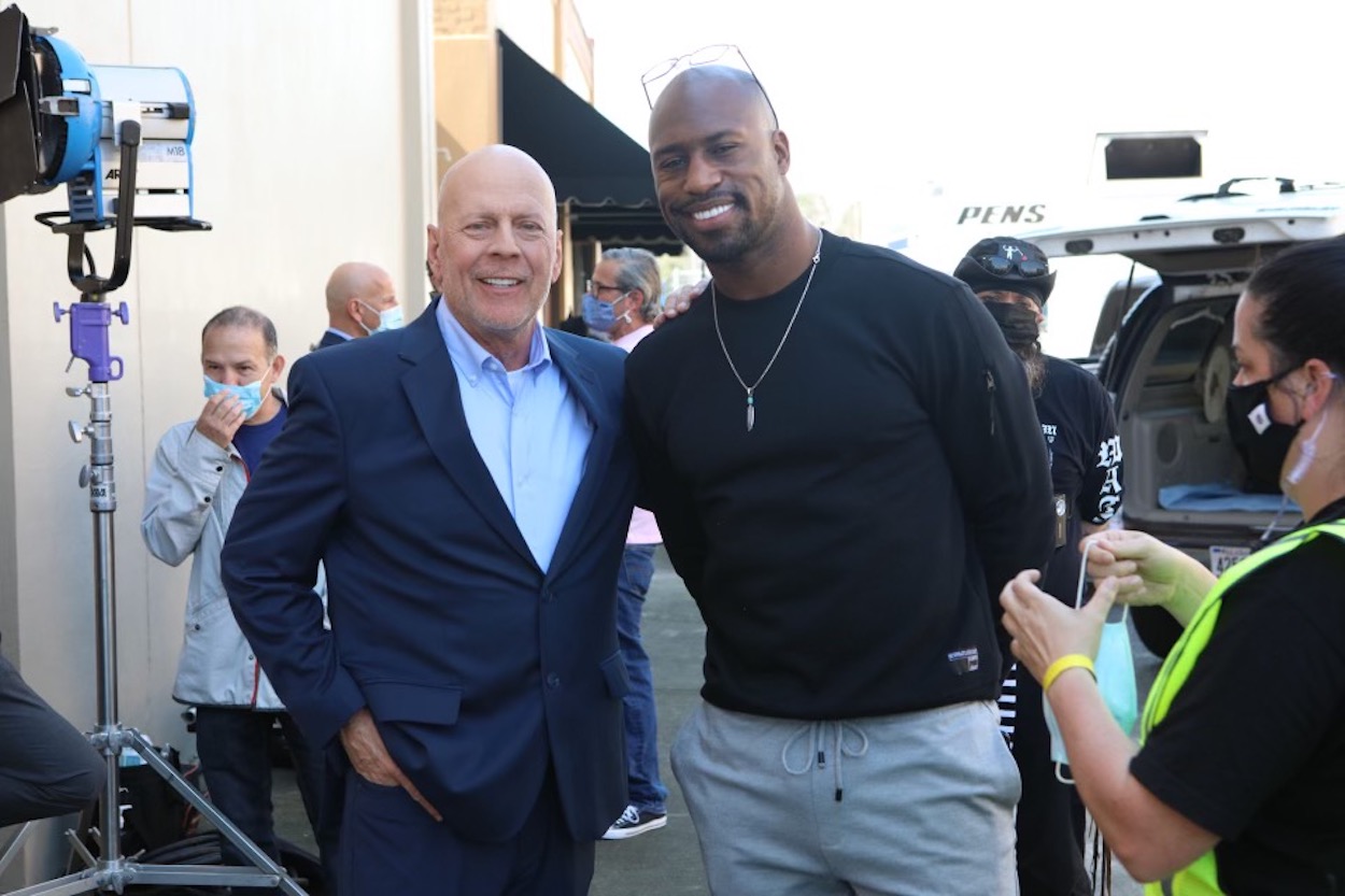 Bruce Willis and Vernon Davis pose for a photo.