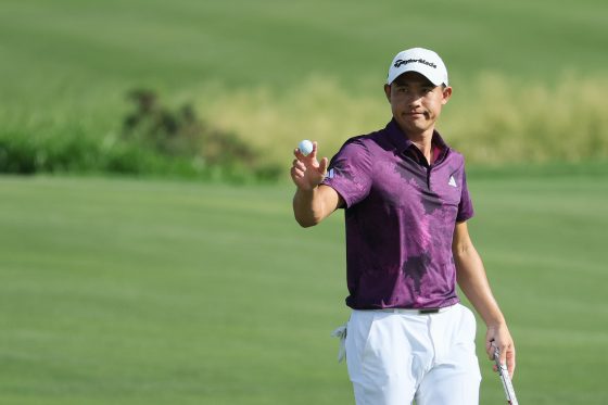 Collin Morikawa waves to the crowd.