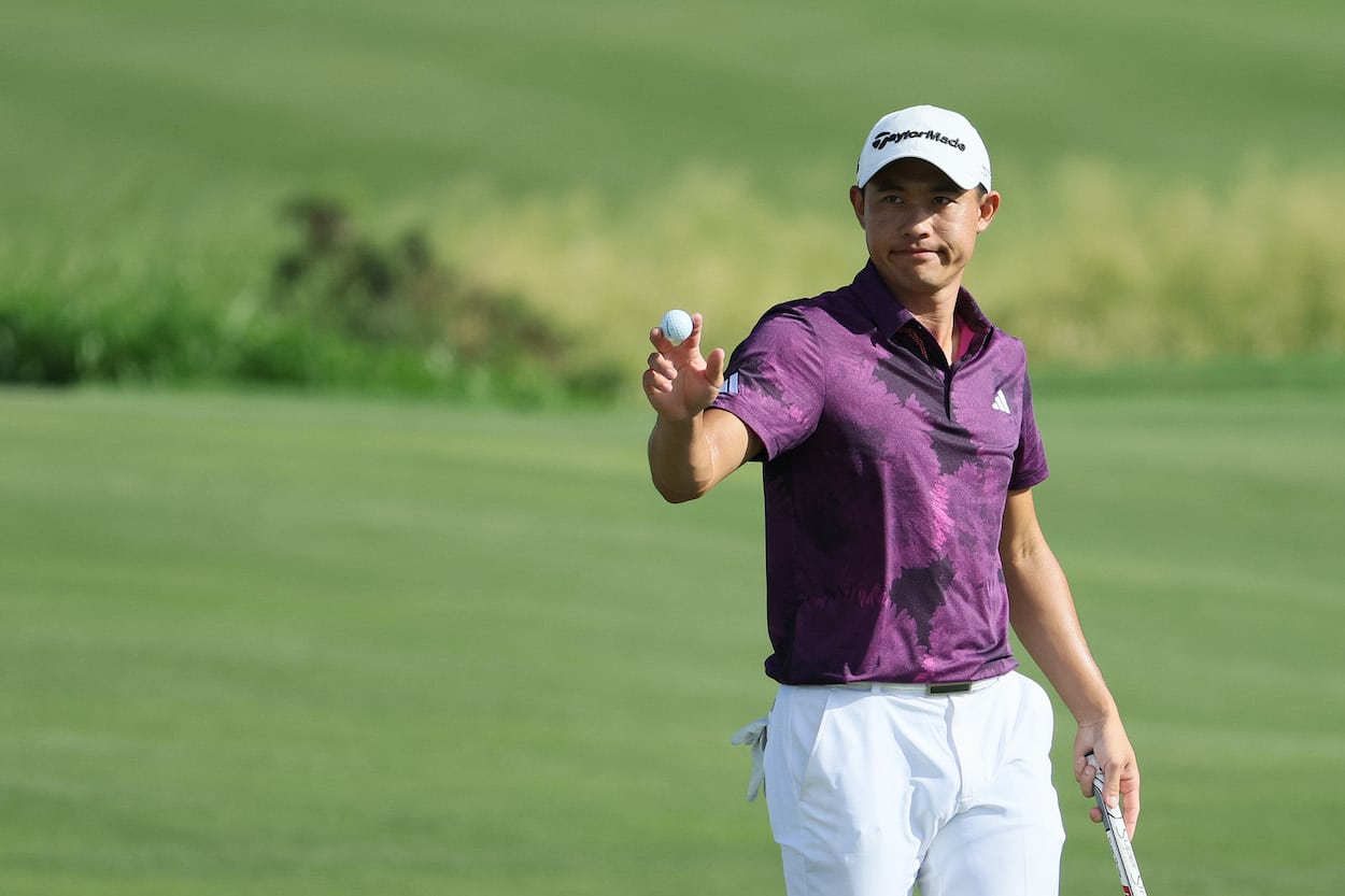 Collin Morikawa waves to the crowd.