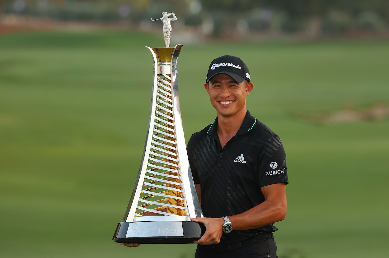 Collin Morikawa poses with a trophy.