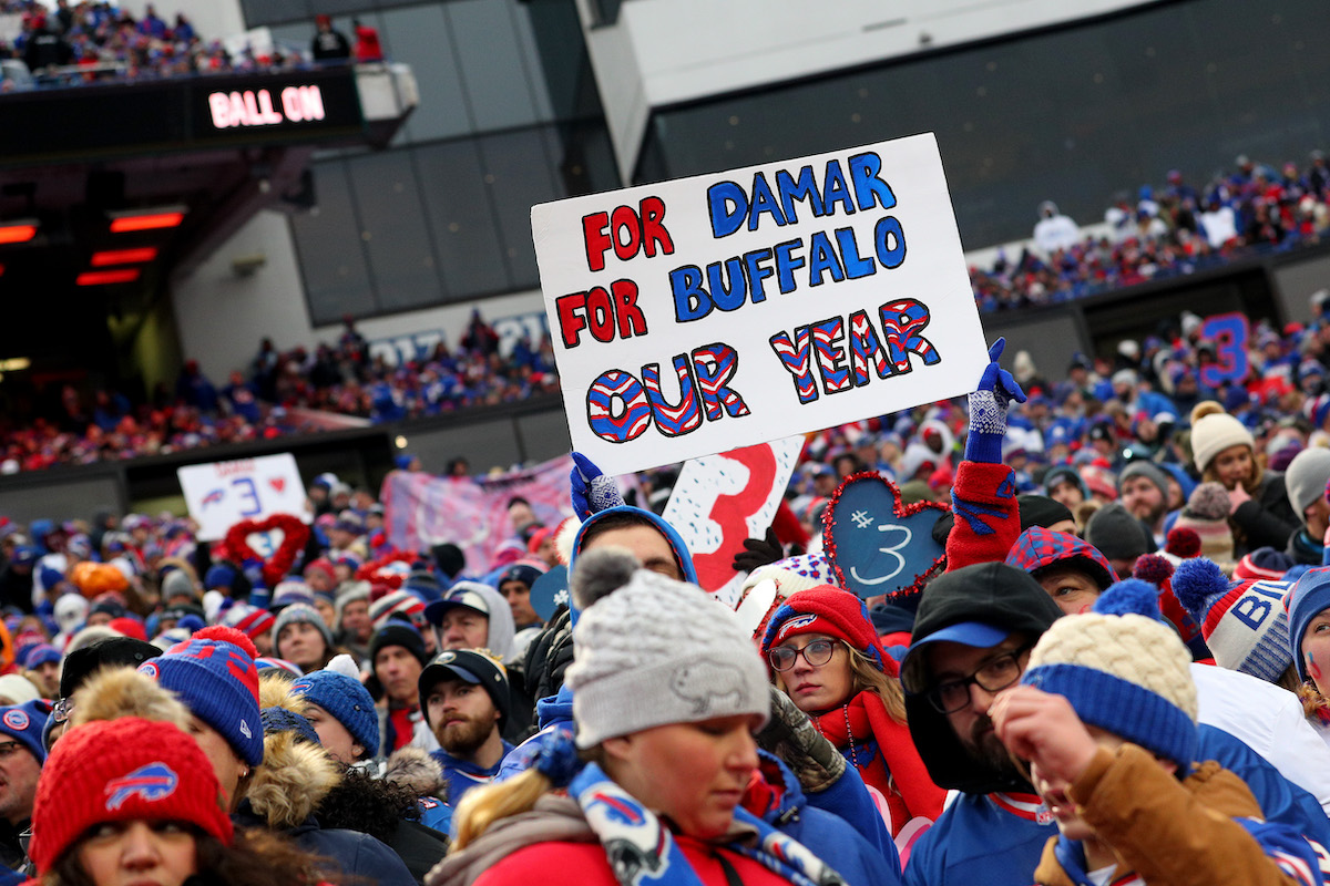 Fans hold up a sign honoring Damar Hamlin of the Buffalo Bills during the fourth quarter of a game between the Bills and Patriots