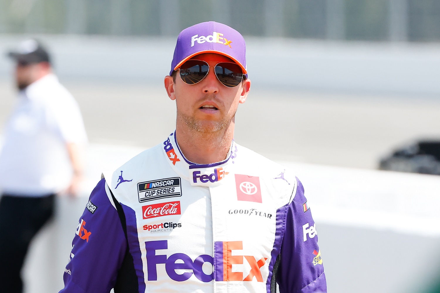 Denny Hamlin walks to driver introductions for the NASCAR Cup Series M&Ms Fan Appreciation 400 on July 24, 2022, at Pocono Raceway.