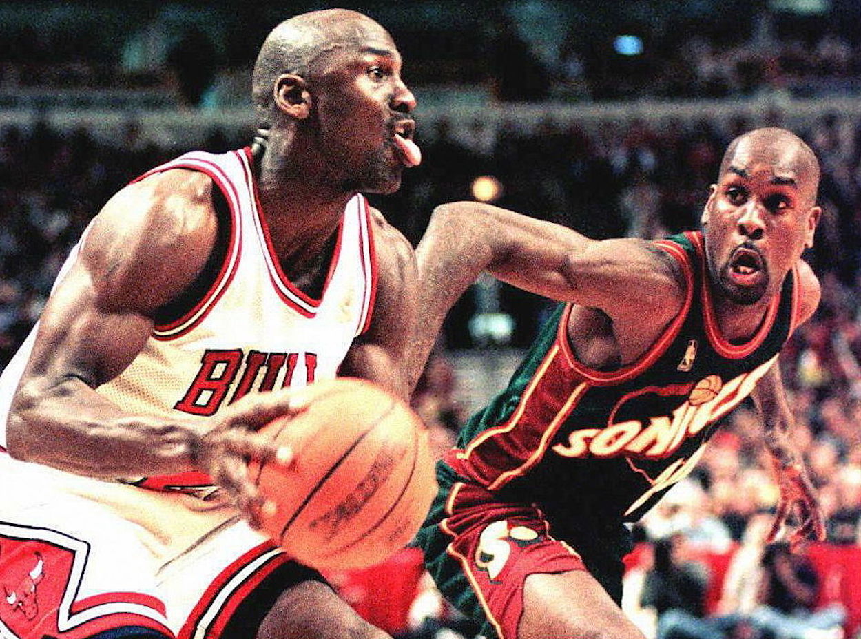 Gary Payton (R) defends Michael Jordan in NBA action.