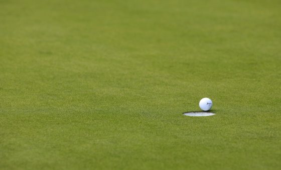 A golf ball sits on the lip.