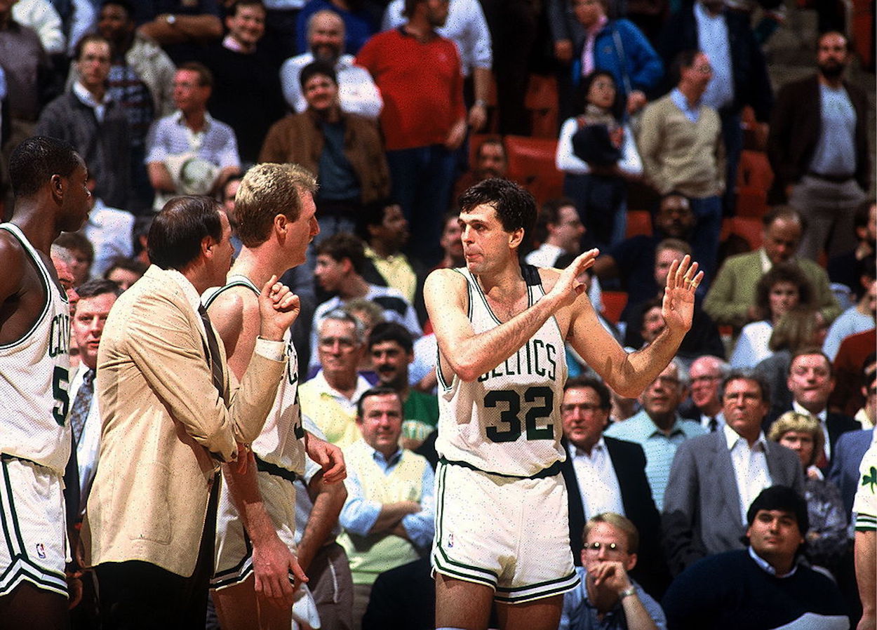 Larry Bird (L) and Kevin McHale (R) talk during a Boston Celtics game.