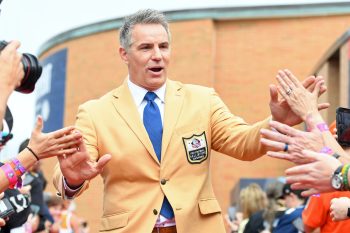 Kurt Warner celebrates with fans.