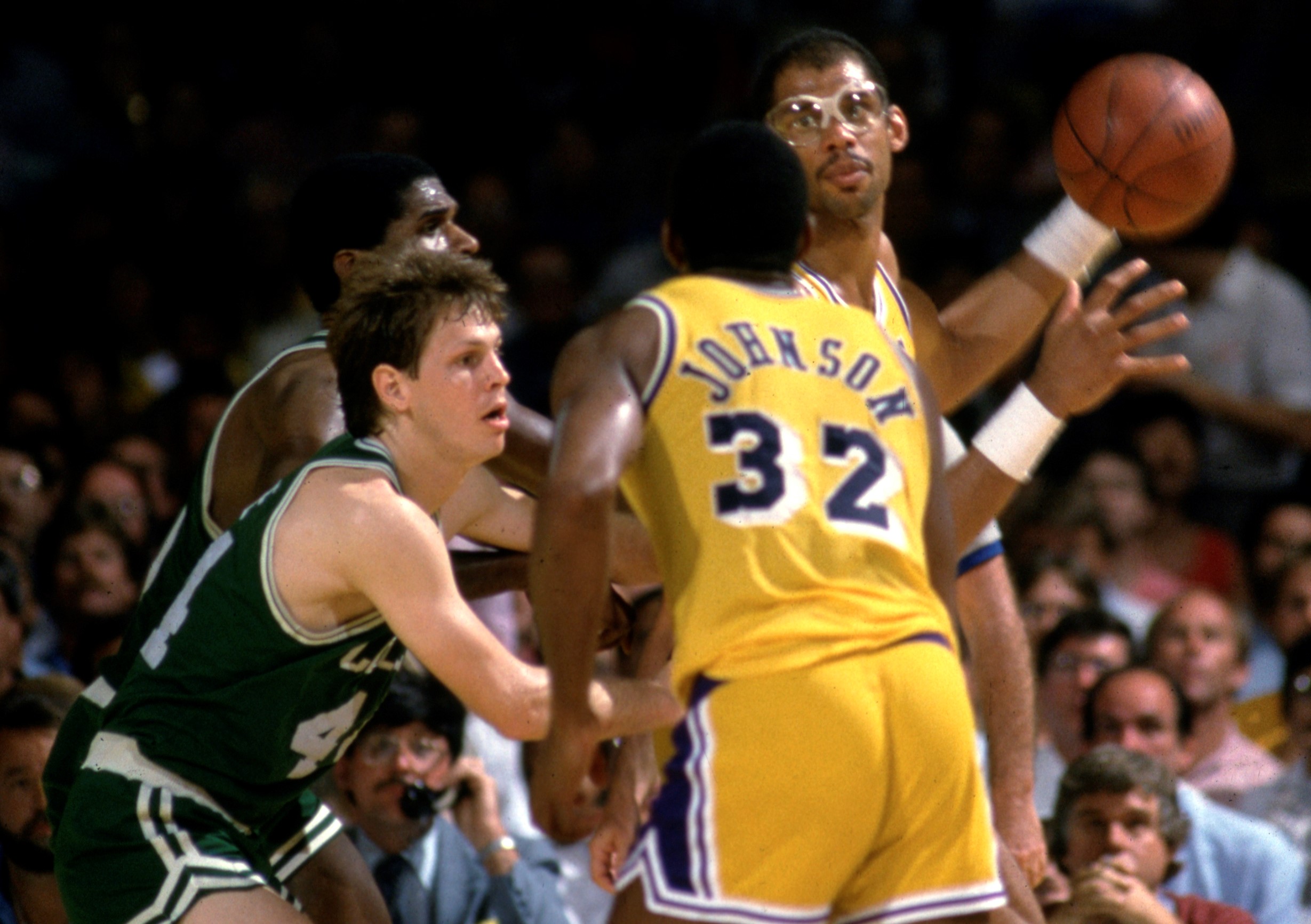 Lakers center Kareem Abdul-Jabbar looks to pass to Magic Johnson who is covered by Celtics guard Danny Ainge.