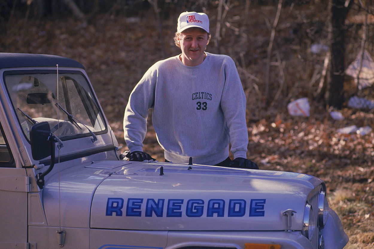 Larry Bird poses with his jeep.