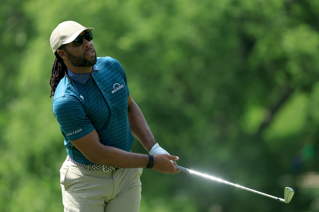 Larry Fitzgerald hits a shot during a pro-am.