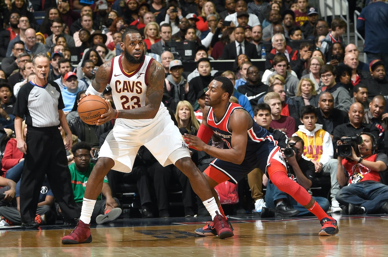 LeBron James posts up John Wall.