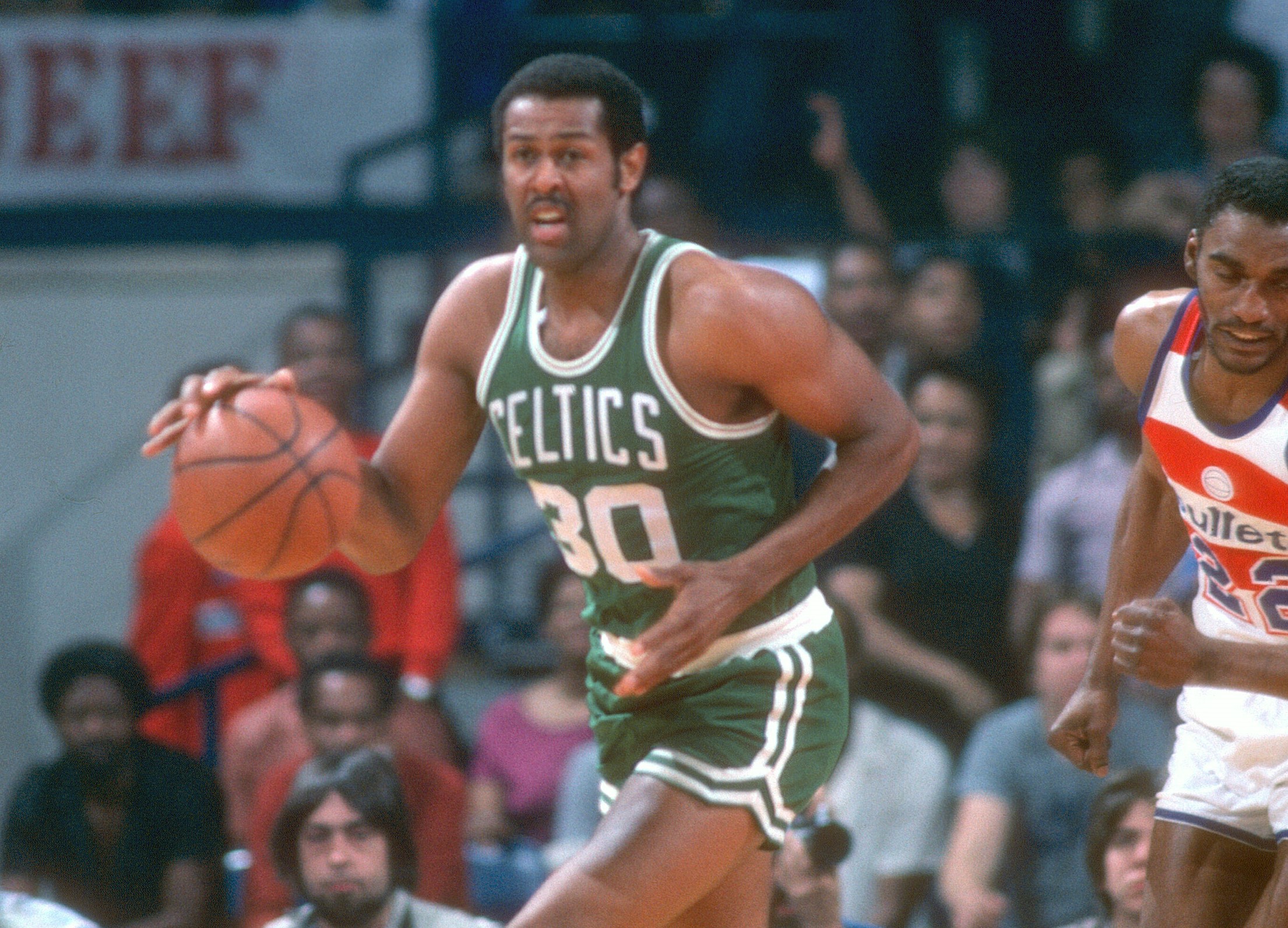 M.L. Carr of the Boston Celtics dribbles the ball up the court.