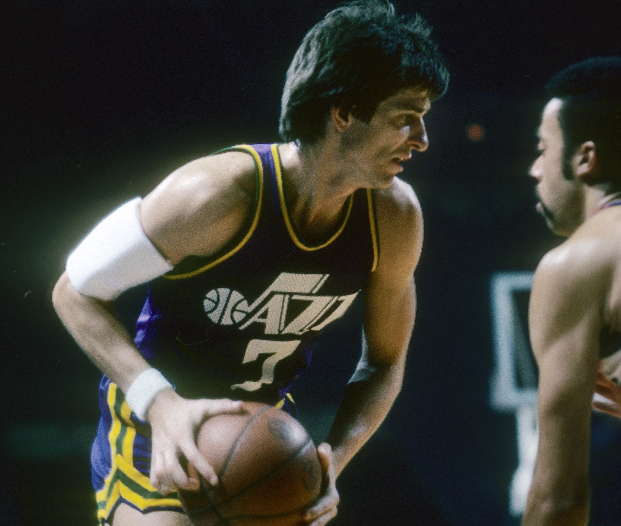 Pete Maravich of the New Orleans Jazz in action guarded closely by Phil Chenier of the Washington Bullets.