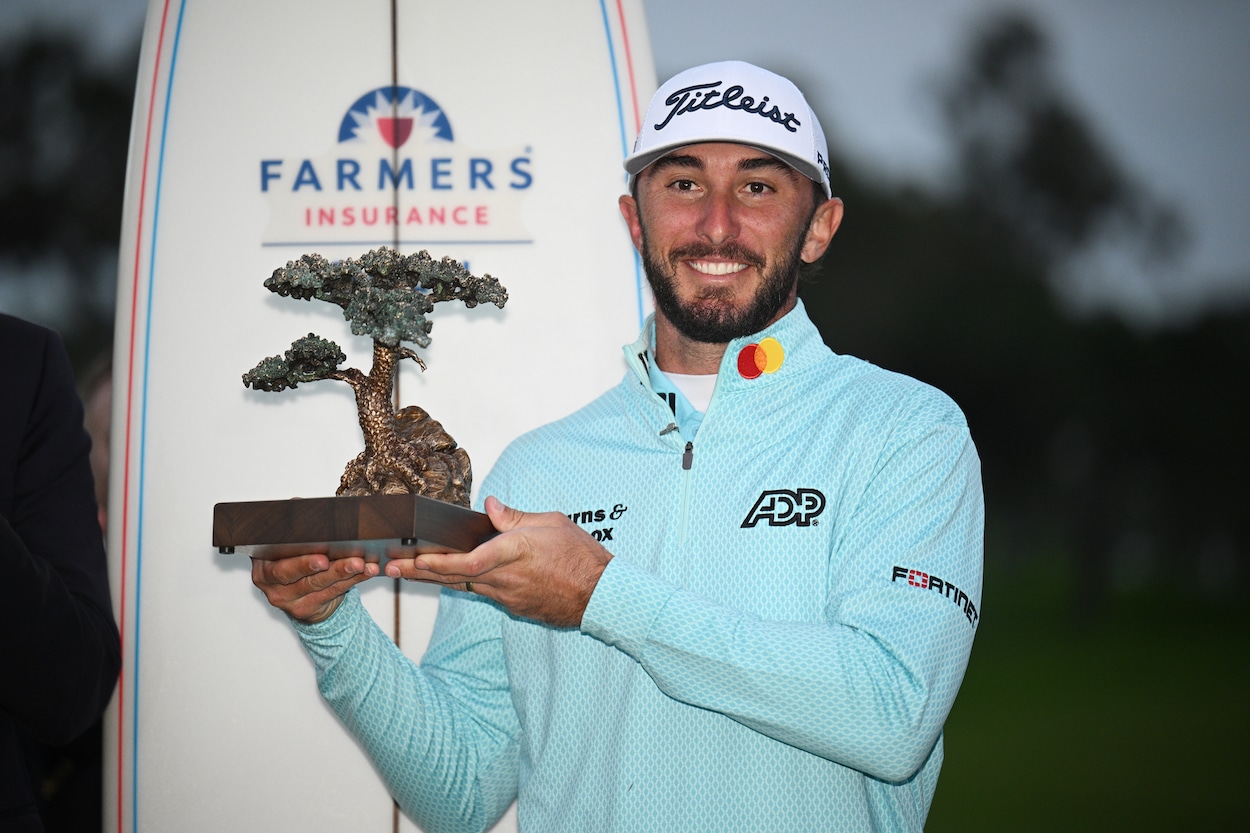 Max Homa poses with the winner's trophy.