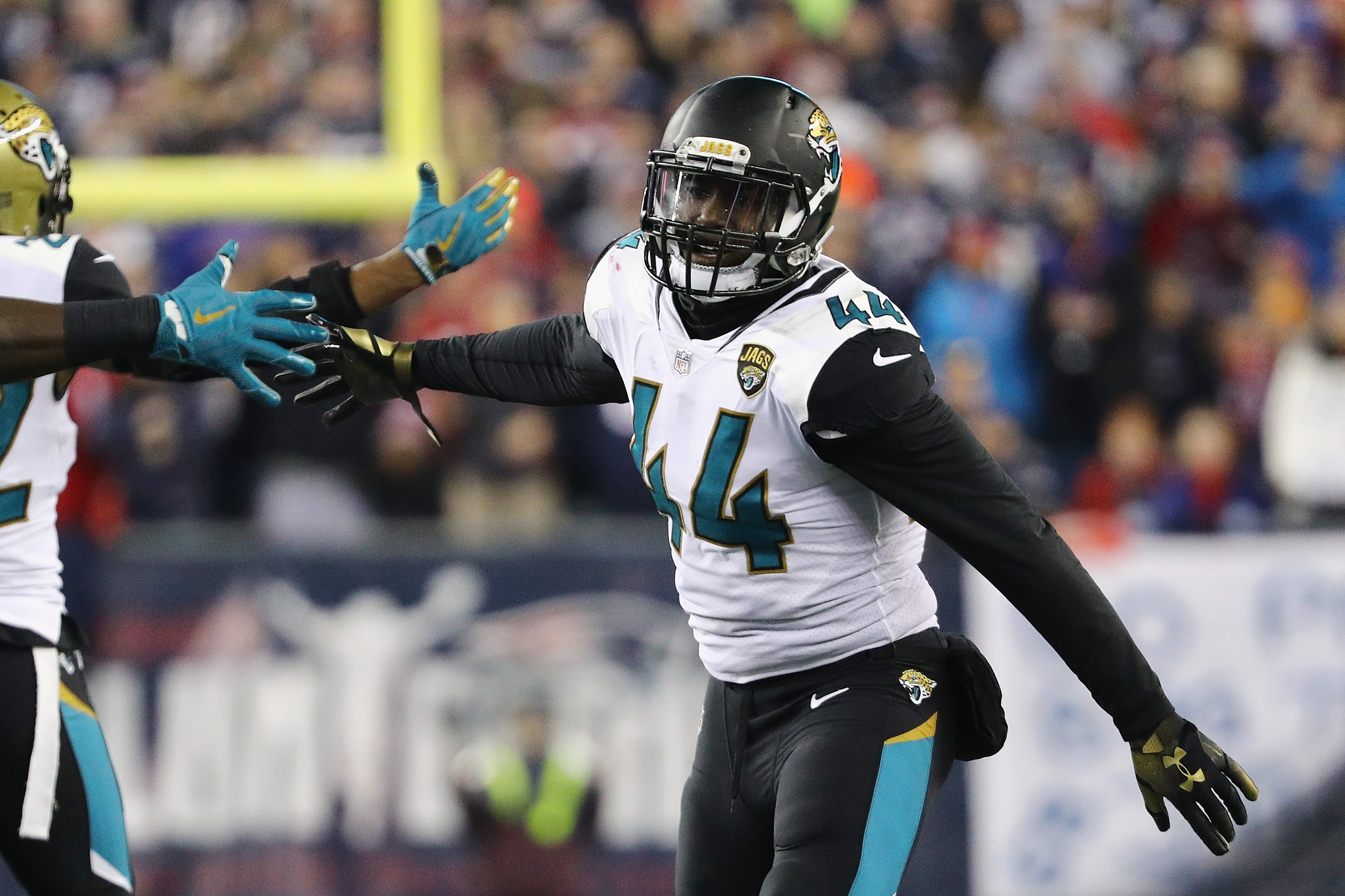 Myles Jack of the Jacksonville Jaguars celebrates with teammates after forcing a fumble.