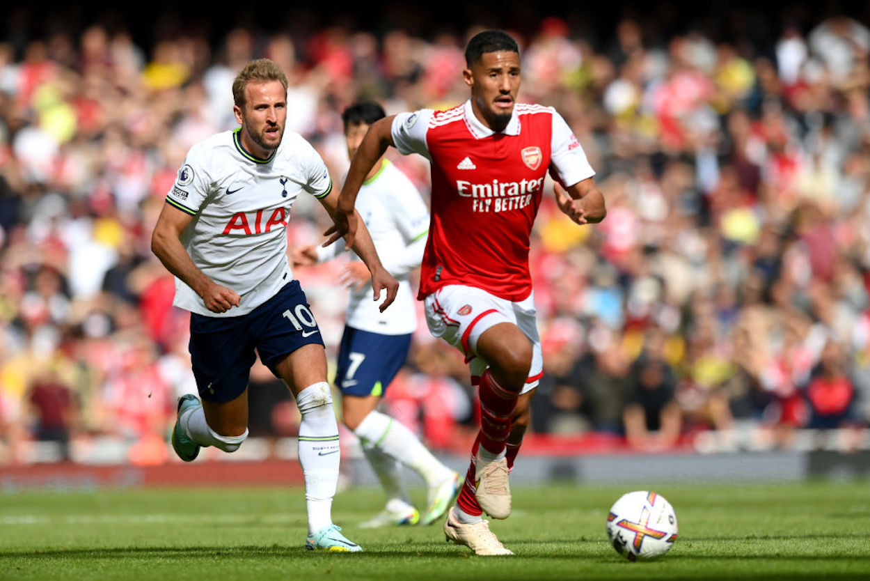 Harry Kane (L) and William Saliba (R) run for a ball during the North London Derby.