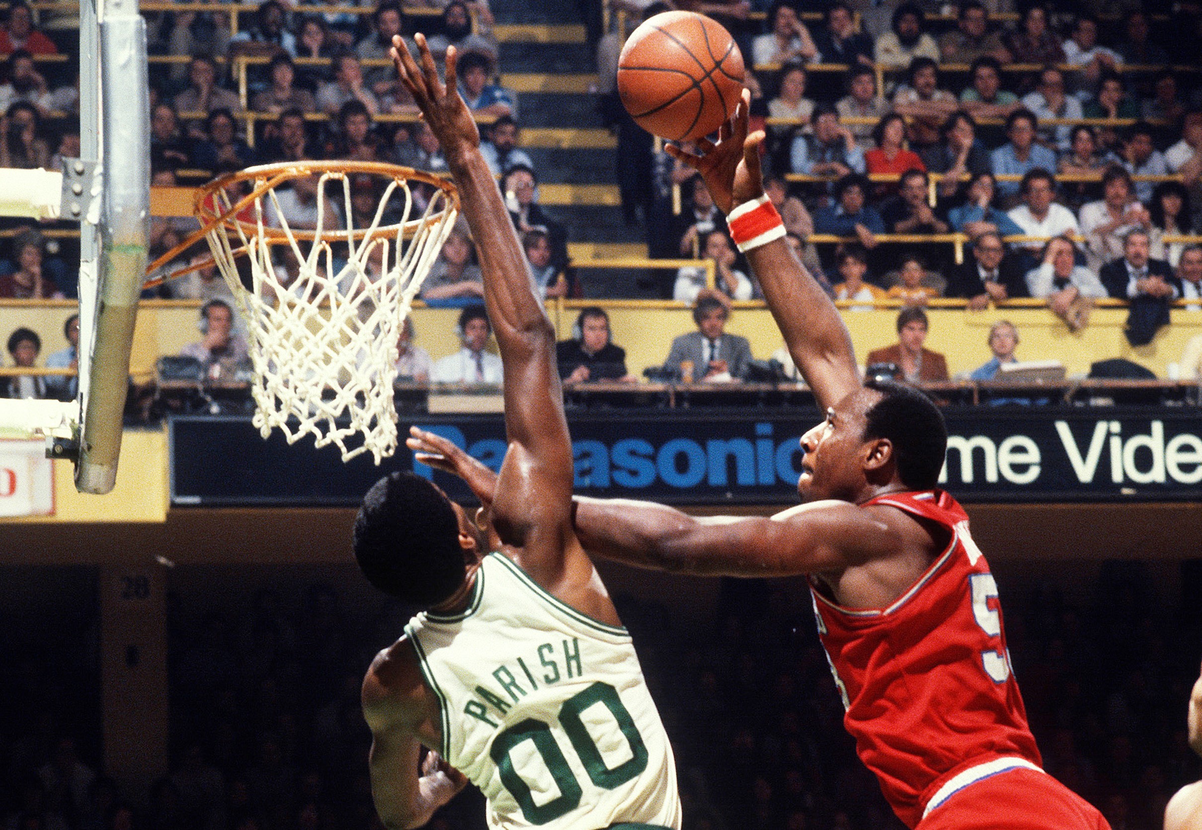 Darryl Dawkins of the Philadelphia 76ers shoots over Robert Parish of the Boston Celtics.