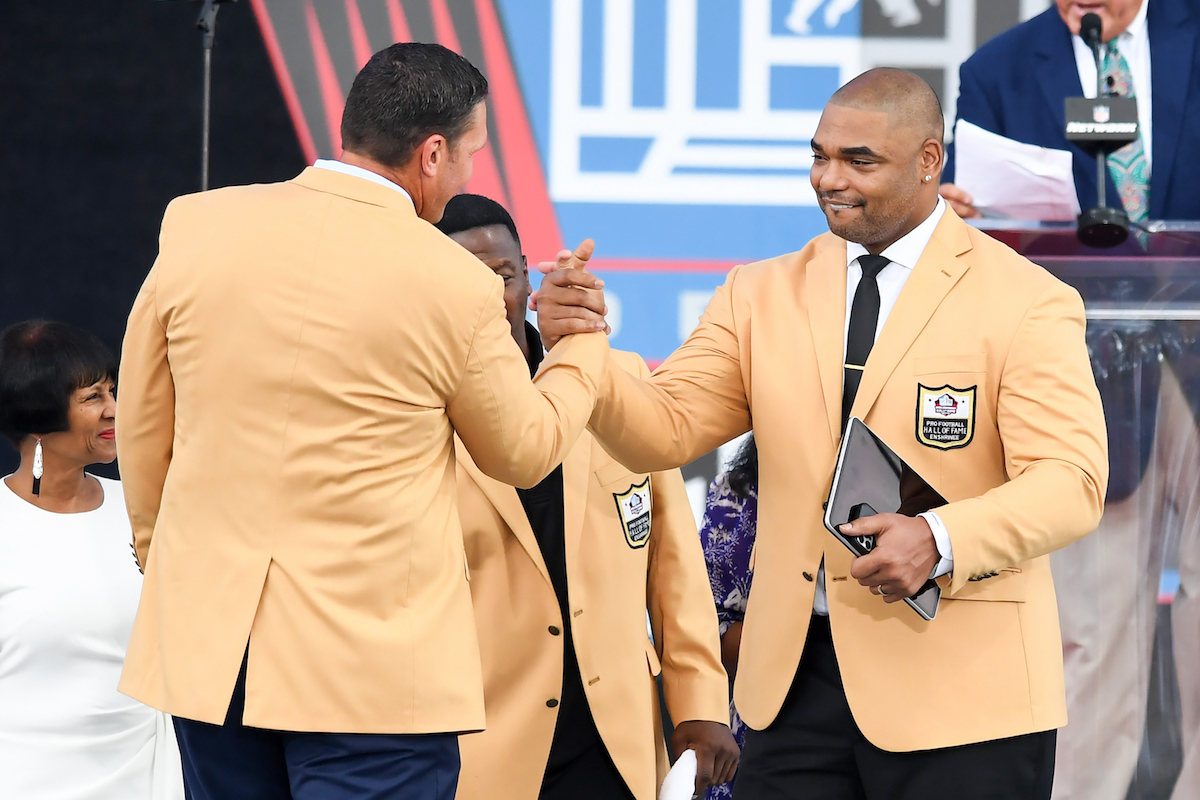 Richard Seymour shakes hands with Tony Boselli during the 202 Pro Football Hall of Fame Enshrinement