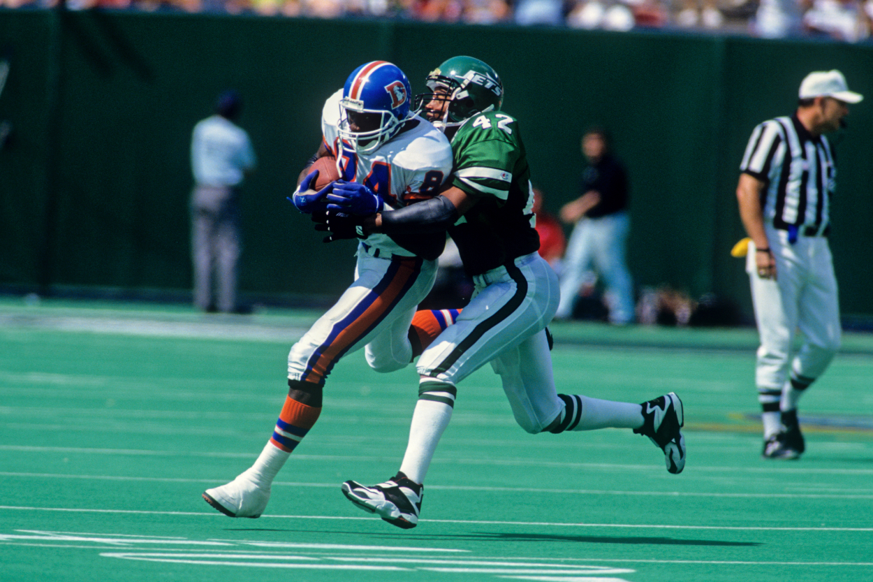 Safety Ronnie Lott of the New York Jets tackles tight end Shannon Sharpe of the Denver Broncos.