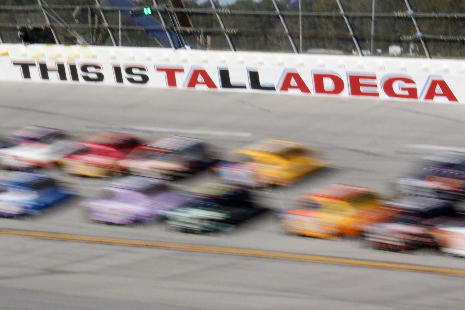Cars streak past the track logo during the NASCAR Cup Series YellaWood 500 on Oct. 2, 2022 at Talladega SuperSpeedway. | Jeff Robinson/Icon Sportswire via Getty Images