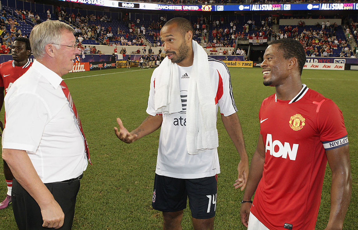 Sir Alex Ferguson (L) and Thierry Henry (R) speak in 2011.