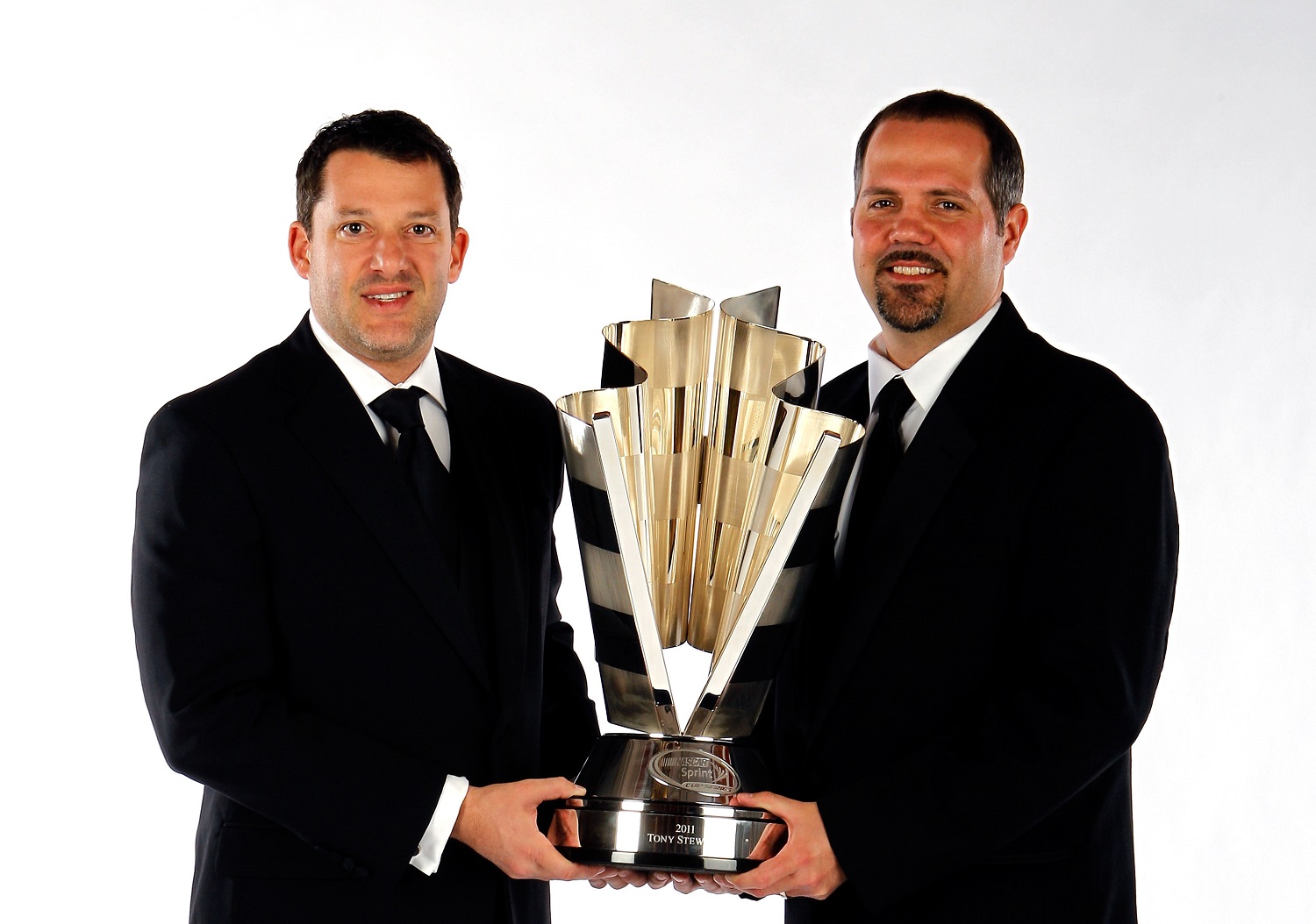 Series champion Tony Stewart and crew chief Darian Grubb pose during the 2011 NASCAR Champions Week awards ceremony.