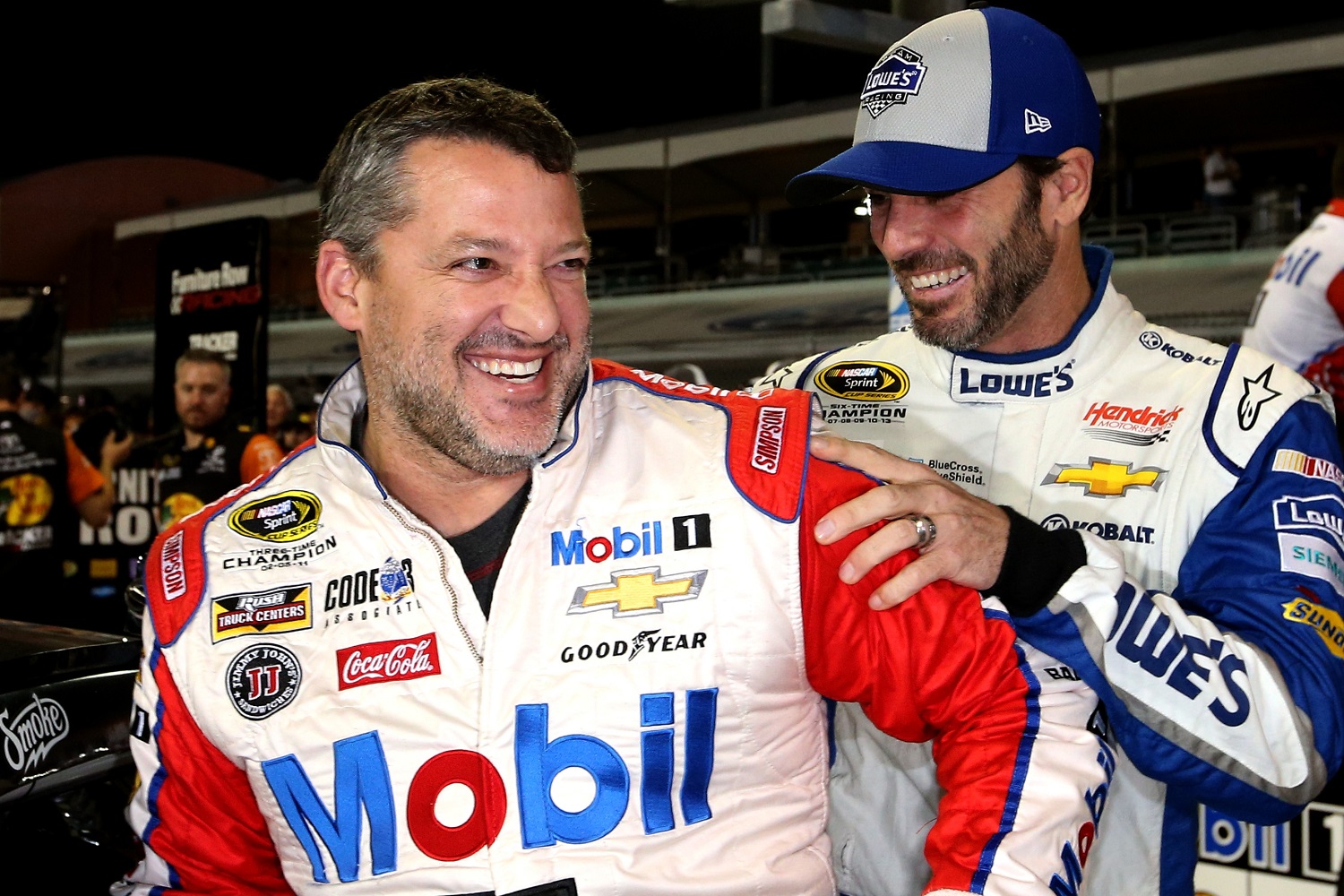 Tony Stewart and Jimmie Johnson joke around on the grid during qualifying for the NASCAR Sprint Cup Series Ford EcoBoost 400 at Homestead-Miami Speedway on Nov. 18, 2016.