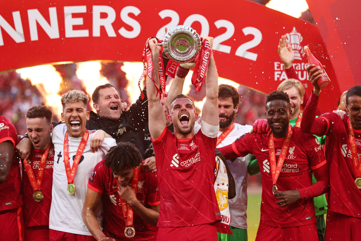 Jordan Henderson of Liverpool lifts the FA Cup in 2022.