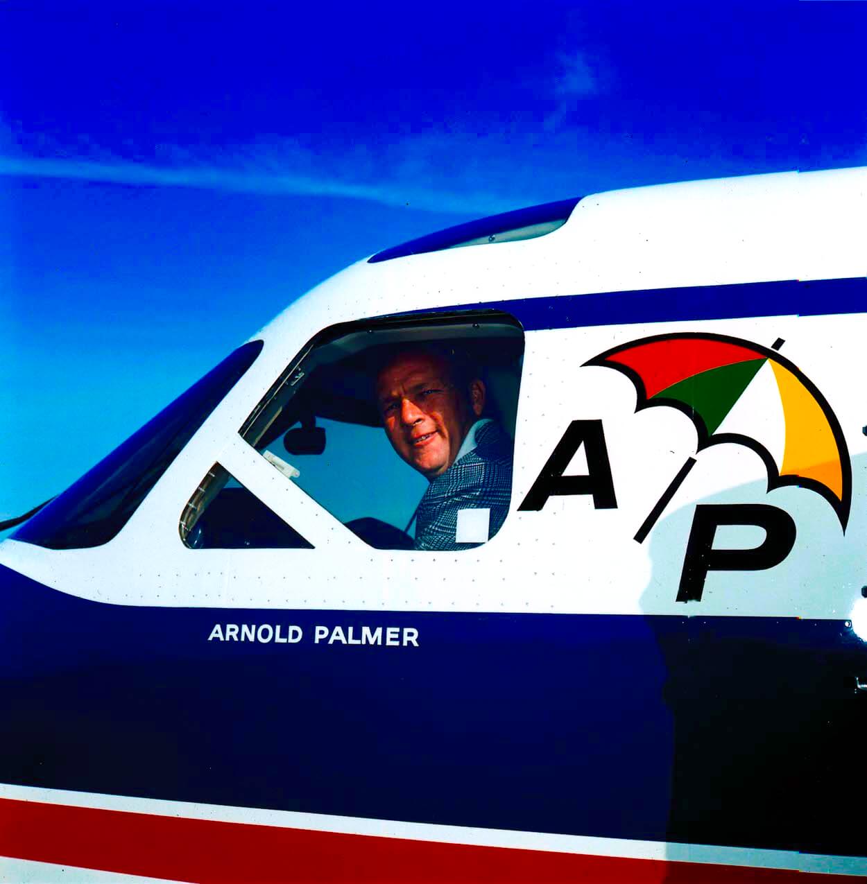 Arnold Palmer looks out the window of his plane.