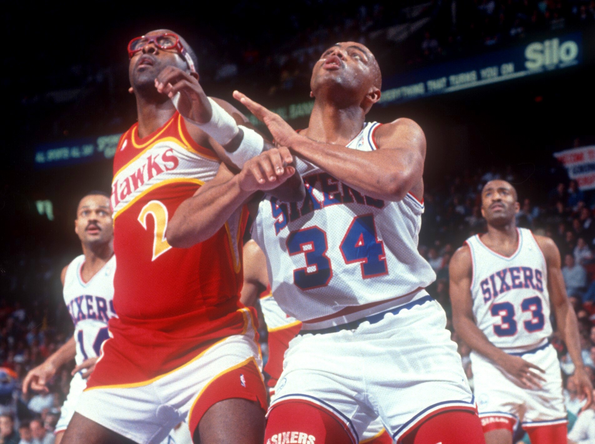 Charles Barkley of the Philadelphia 76ers battles with Moses Malone of the Atlanta Hawks.