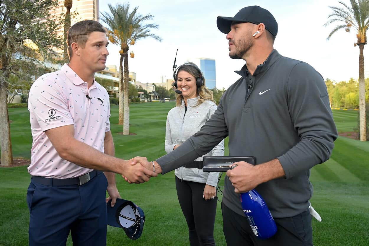 Bryson DeChambeau and Brooks Koepka shake hands.