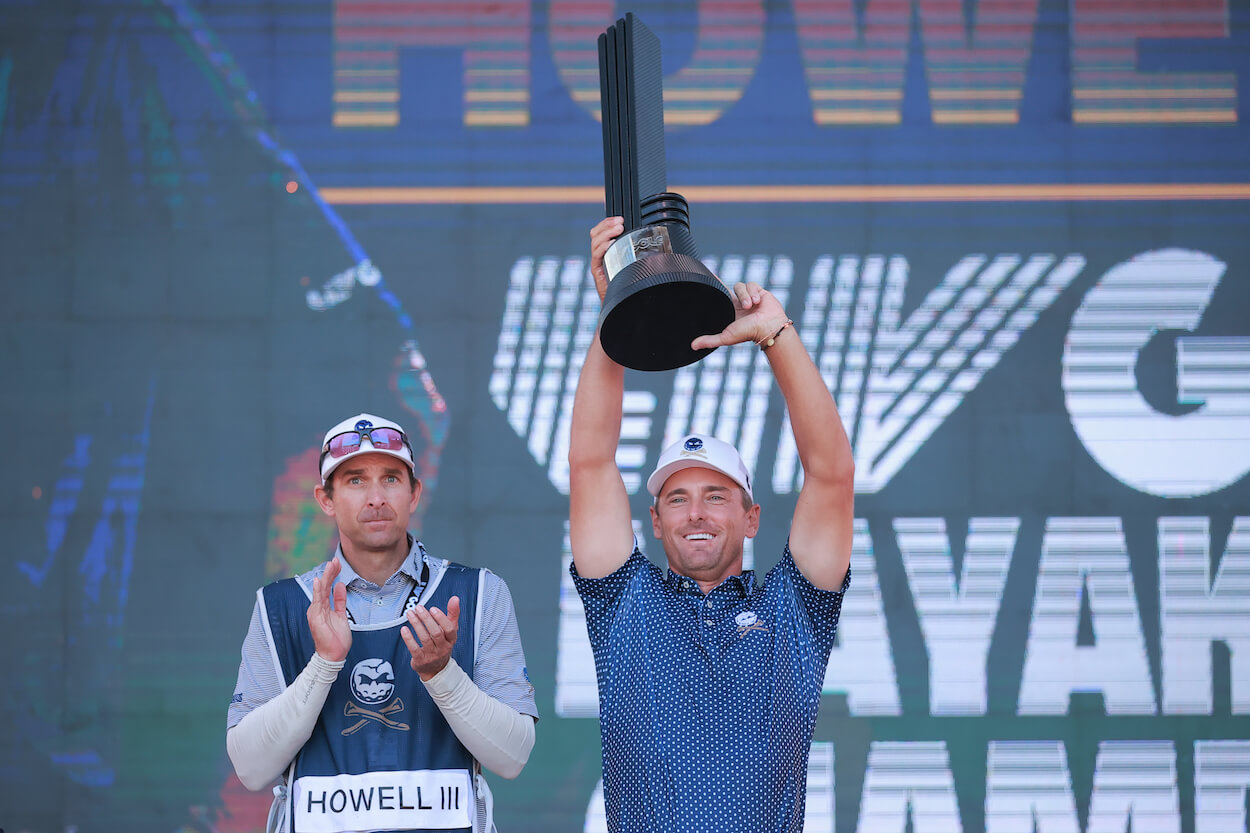 Charles Howell III celebrates with the LIV Golf trophy.