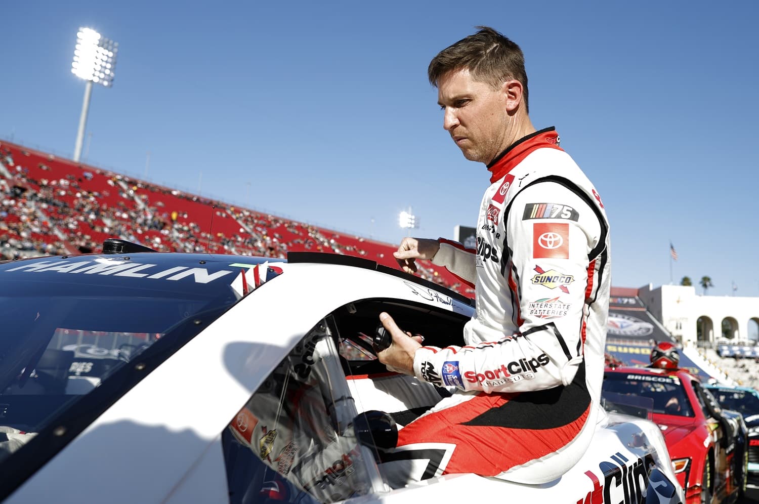 Denny Hamlin enters his car for a qualifying heat in the NASCAR Clash at the Coliseum at Los Angeles Memorial Coliseum on Feb. 5, 2023. | Chris Graythen/Getty Images