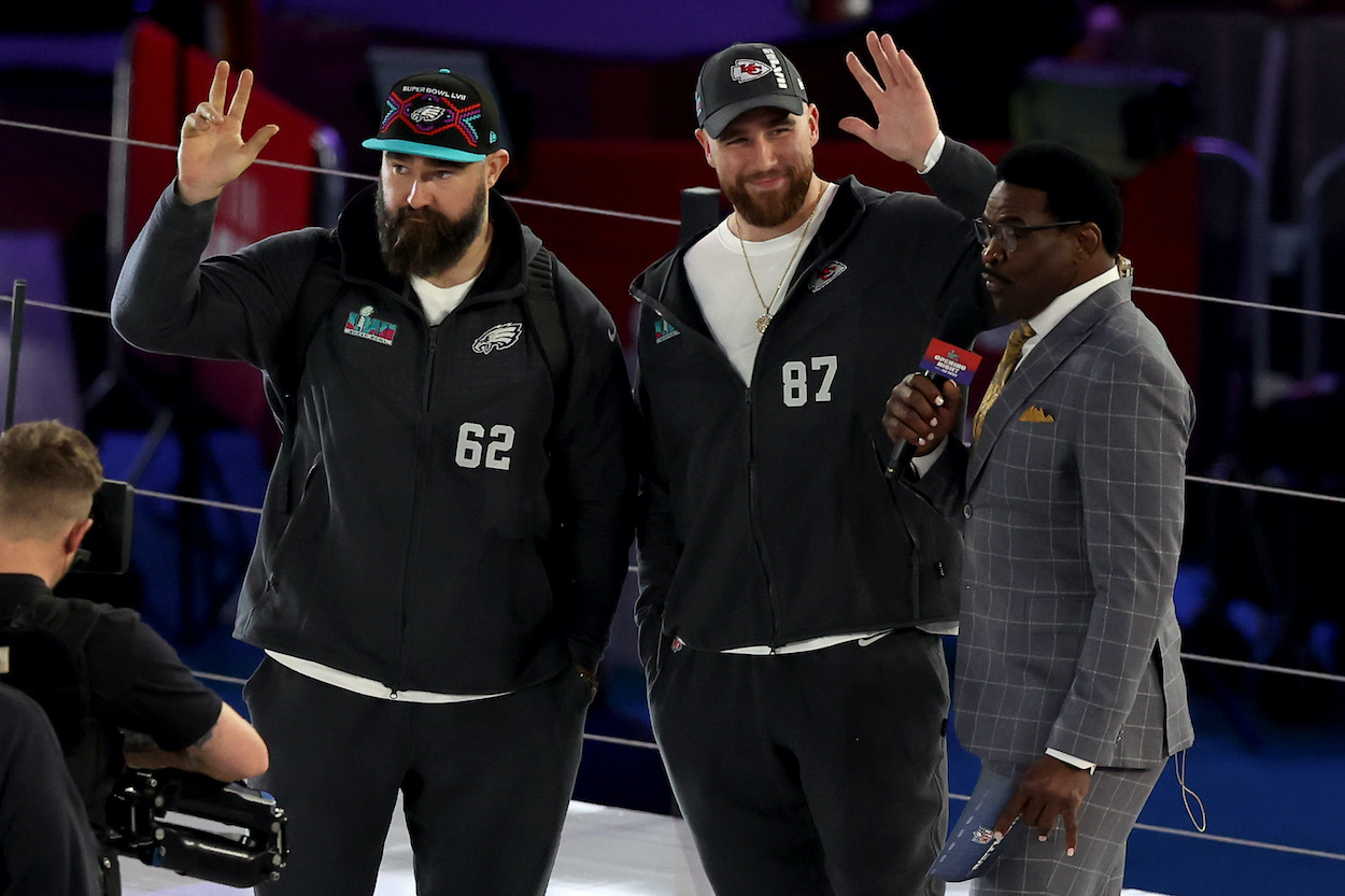 Jason Kelce and Travis Kelce wave to the crowd.