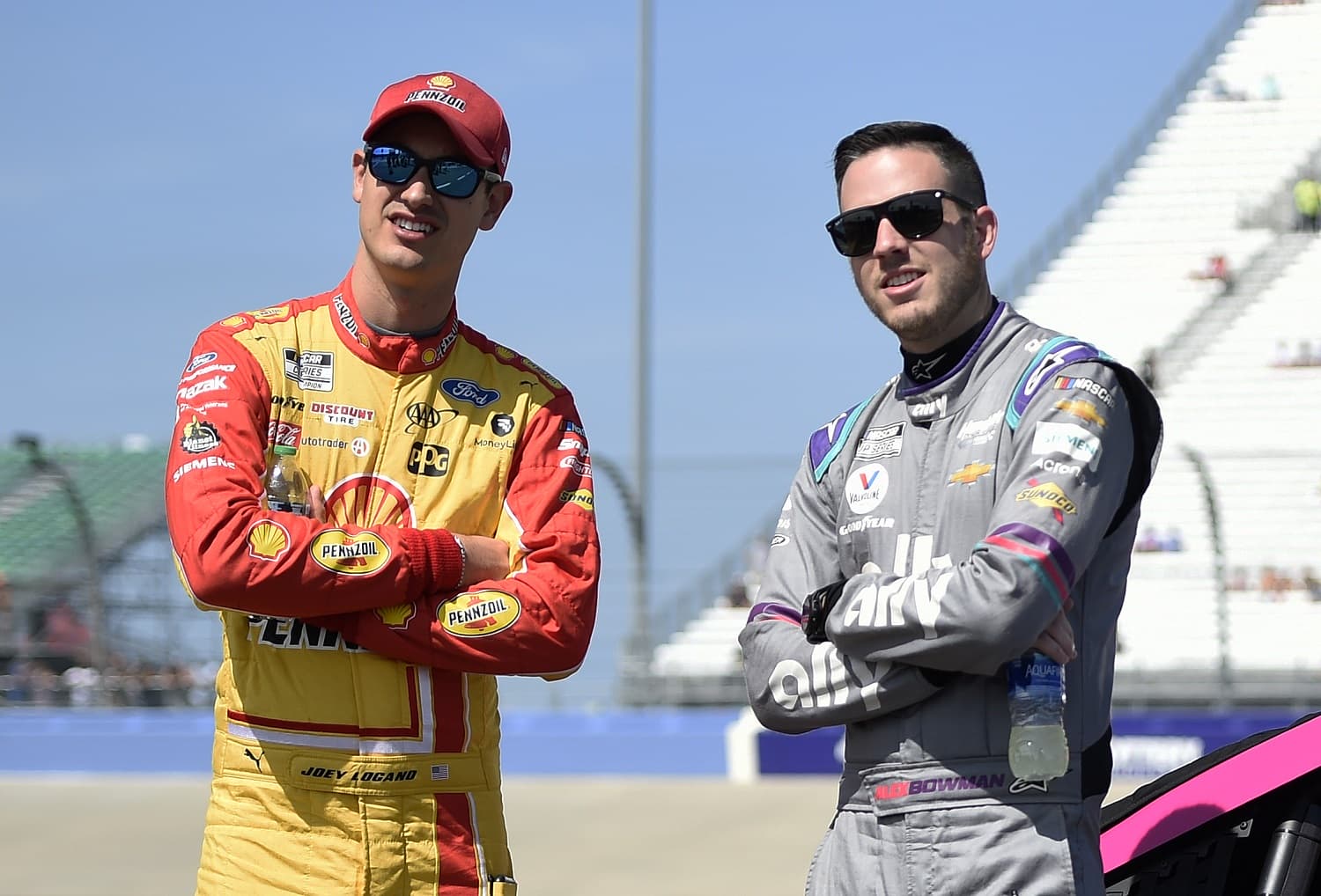 Joey Logano and Alex Bowman talk on the grid during qualifying for the NASCAR Cup Series Ally 400 at Nashville Superspeedway on June 20, 2021.