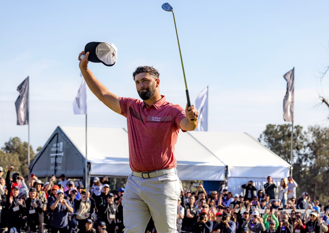 Jon Rahm waves to the crowd.