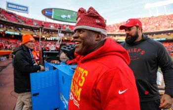 Chiefs offensive coordinator Eric Bieniemy smiles as he walks off the field after a win