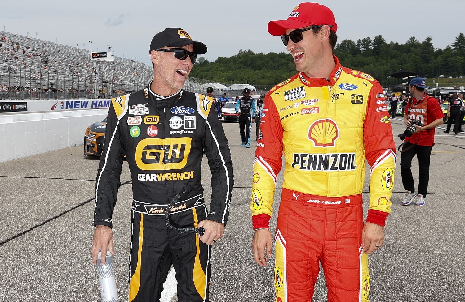 Kevin Harvick and Joey Logano walk the grid during qualifying for the NASCAR Cup Series Ambetter 301 at New Hampshire Motor Speedway on July 16, 2022.