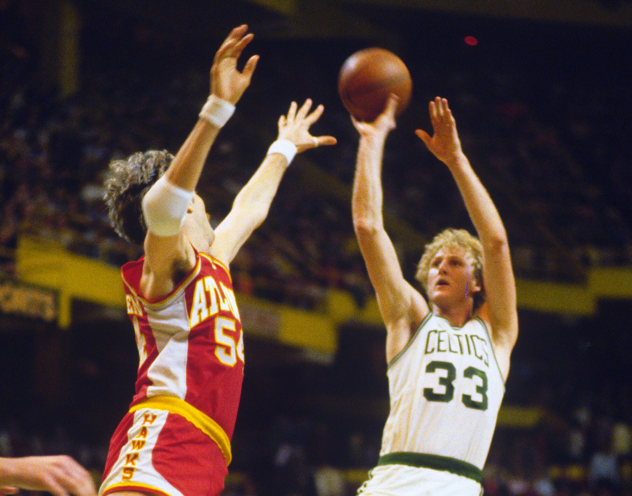 Larry Bird of the Boston Celtics shoots over Mark Landsberger of the Atlanta Hawks.