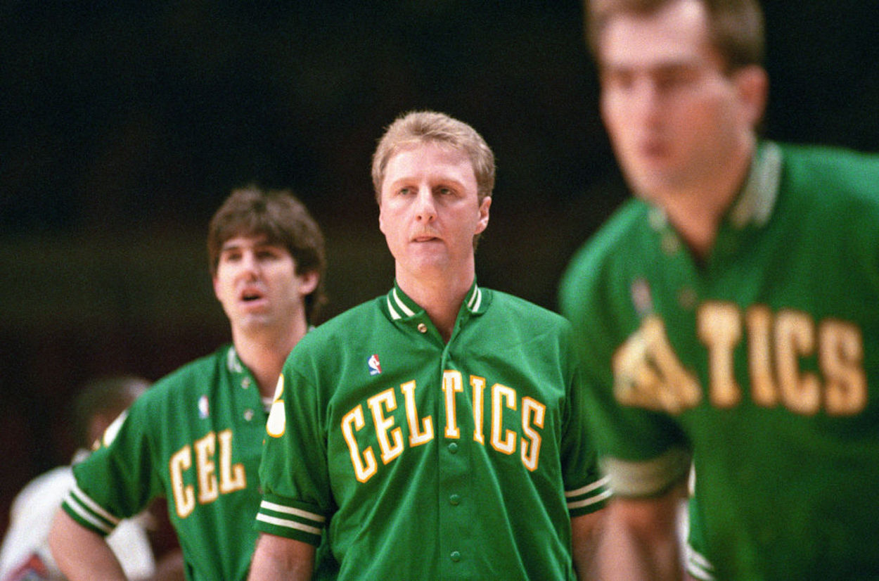 Larry Bird (C) warms up before a Boston Celtics game.