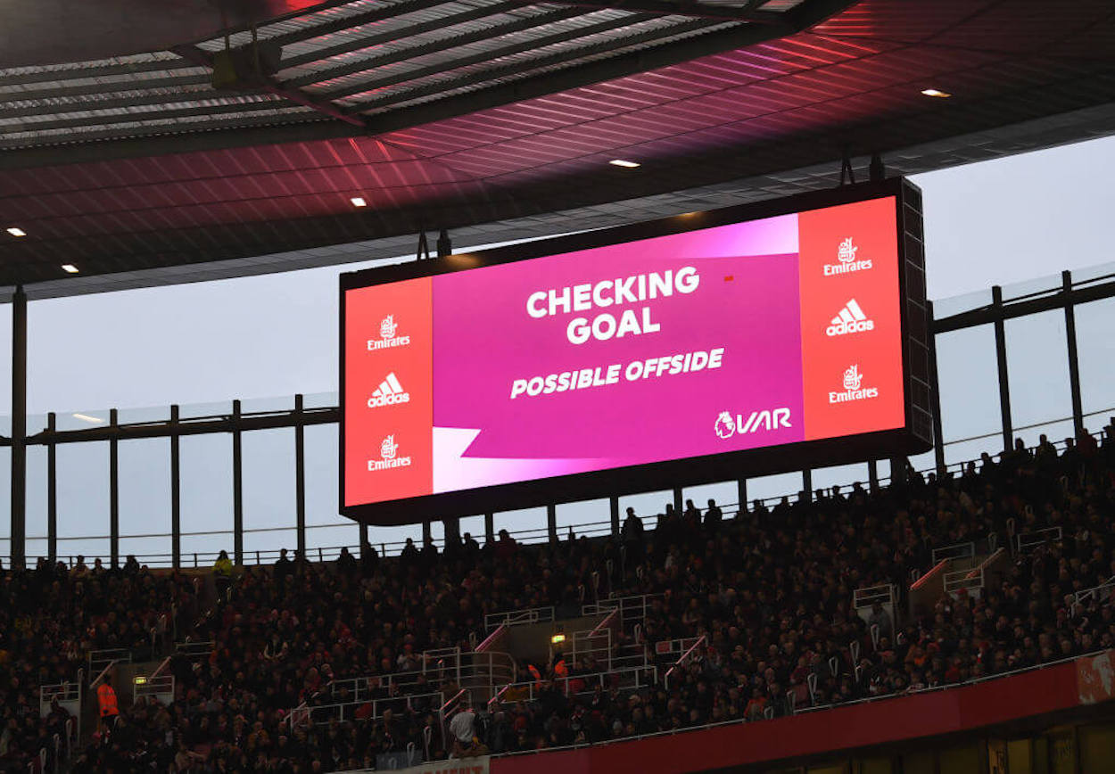 A screen at Emirates Stadium showing a VAR check in progress.