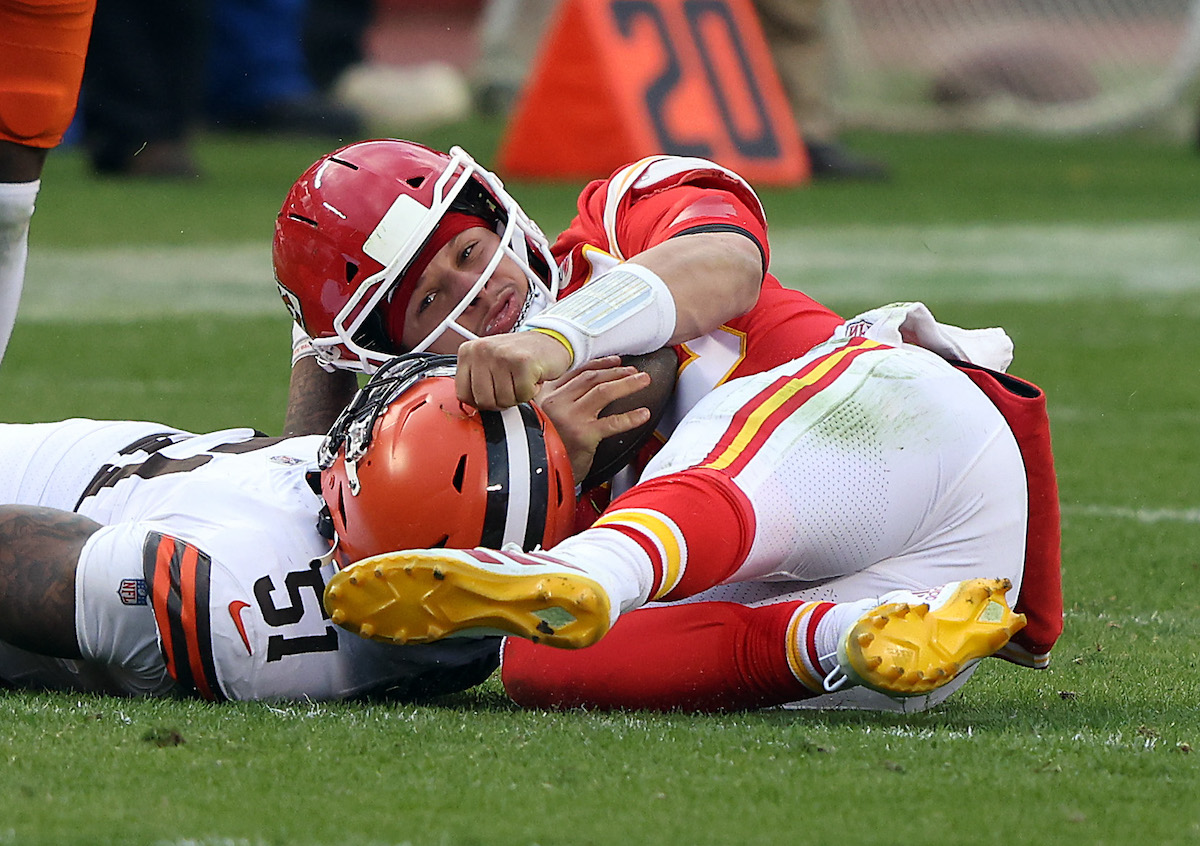 Quarterback Patrick Mahomes of the Kansas City Chiefs is sacked by outside linebacker Mack Wilson of the Cleveland Browns in the third quarter of the 2021 AFC Divisional Playoff game